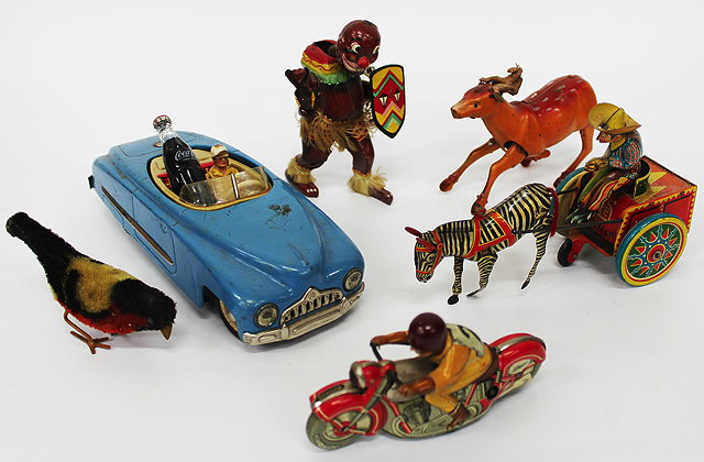 Appraisal: A GERMAN TIN PLATE TOY 'GALLOP ' COWBOY and a