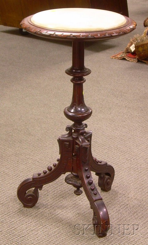 Appraisal: Victorian Renaissance Revival White Marble-top Carved Walnut Stand with Tri-pod