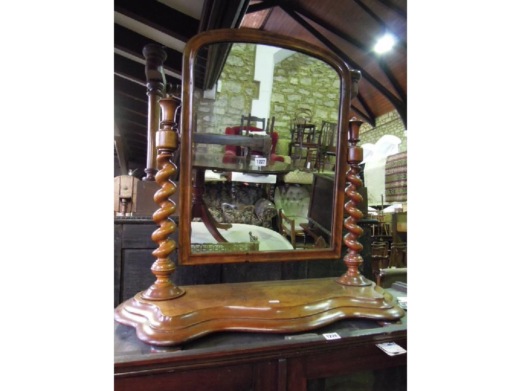 Appraisal: A Victorian walnut toilet mirror of arched form raised on