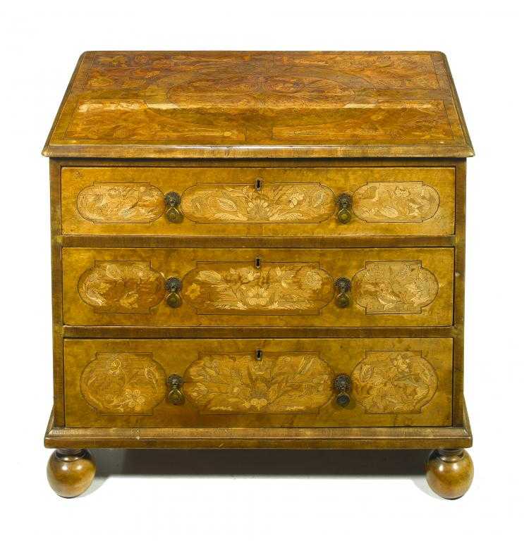 Appraisal: A WALNUT AND MARQUETRY CHEST OF DRAWERS the crossbanded top