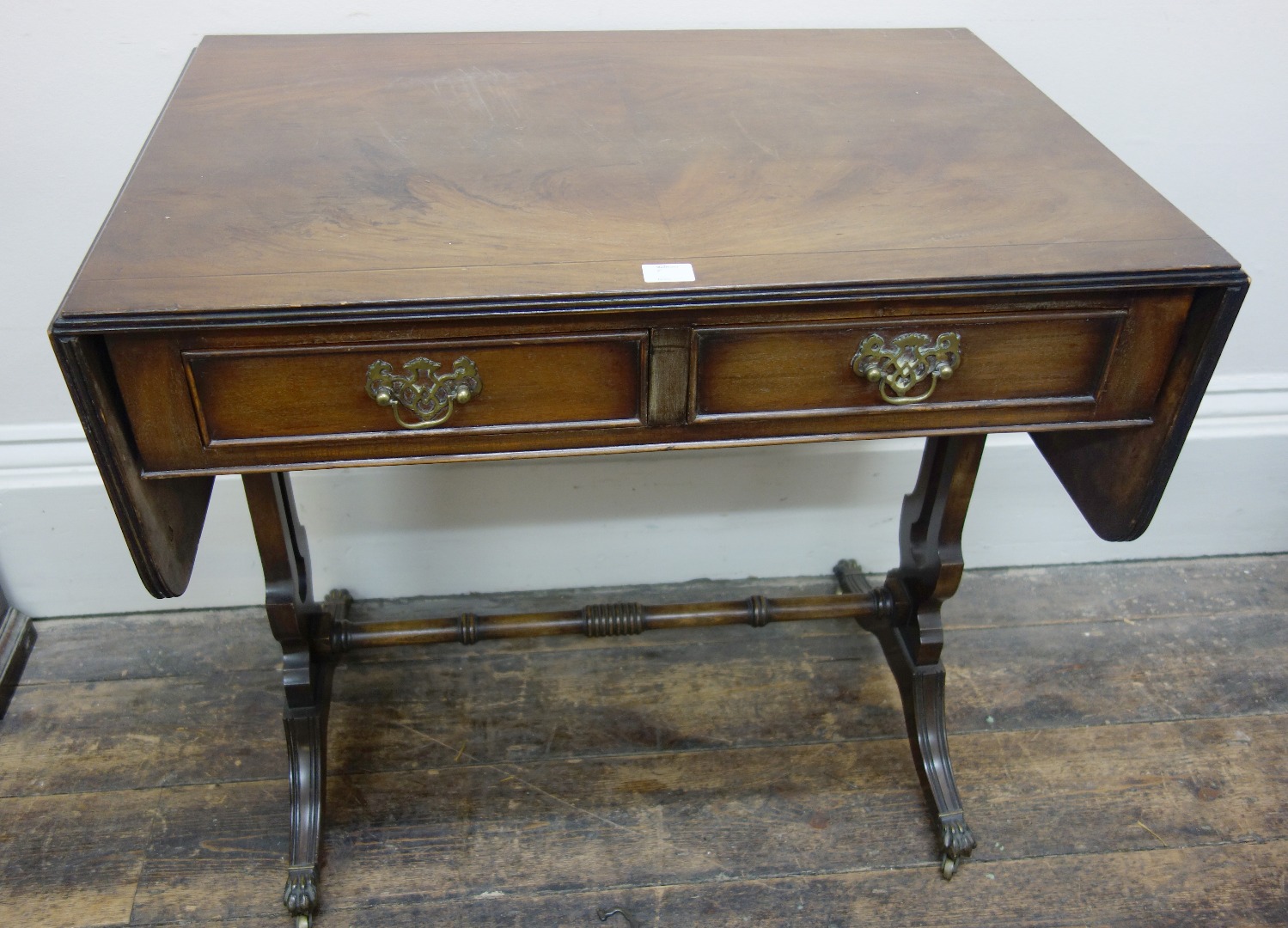 Appraisal: A reproduction Regency style mahogany and banded sofa table cm