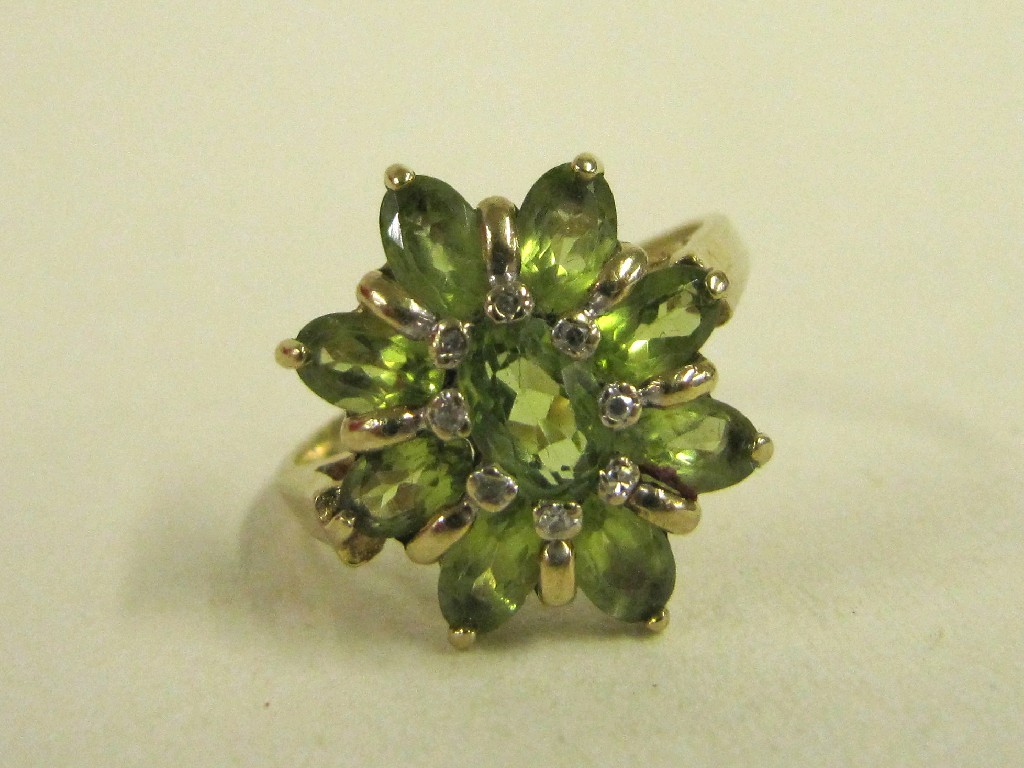 Appraisal: Nine carat gold peridot and diamond cluster ring