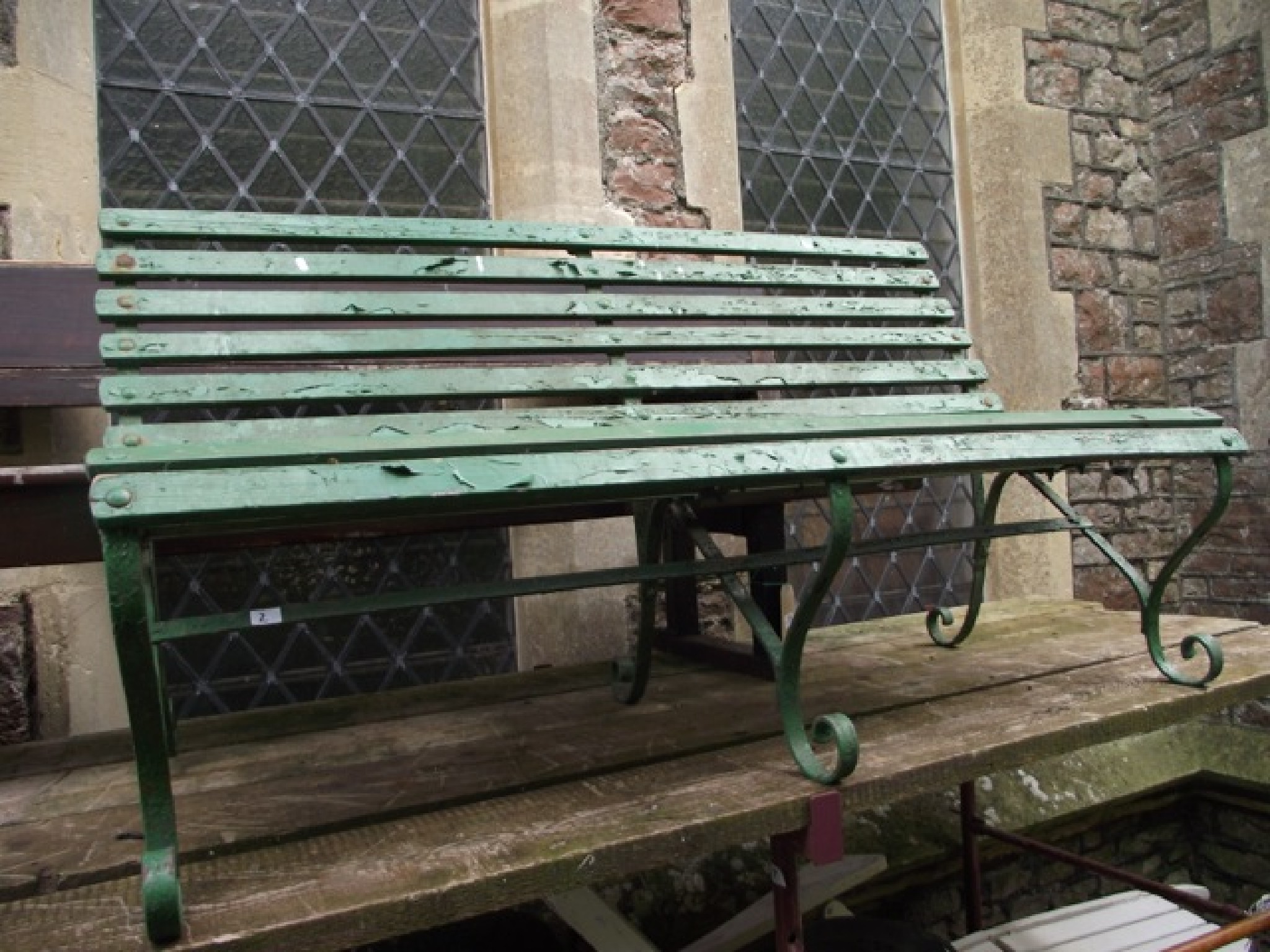 Appraisal: A sprung steel garden bench with wooden slatted seat and