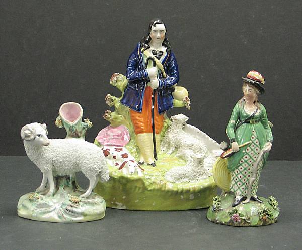 Appraisal: Three Staffordshire pottery figures th early th century Comprising lady