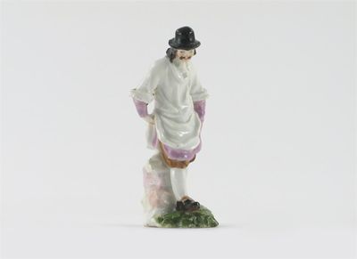 Appraisal: A miniature Meissen figure of a tradesman his hands in