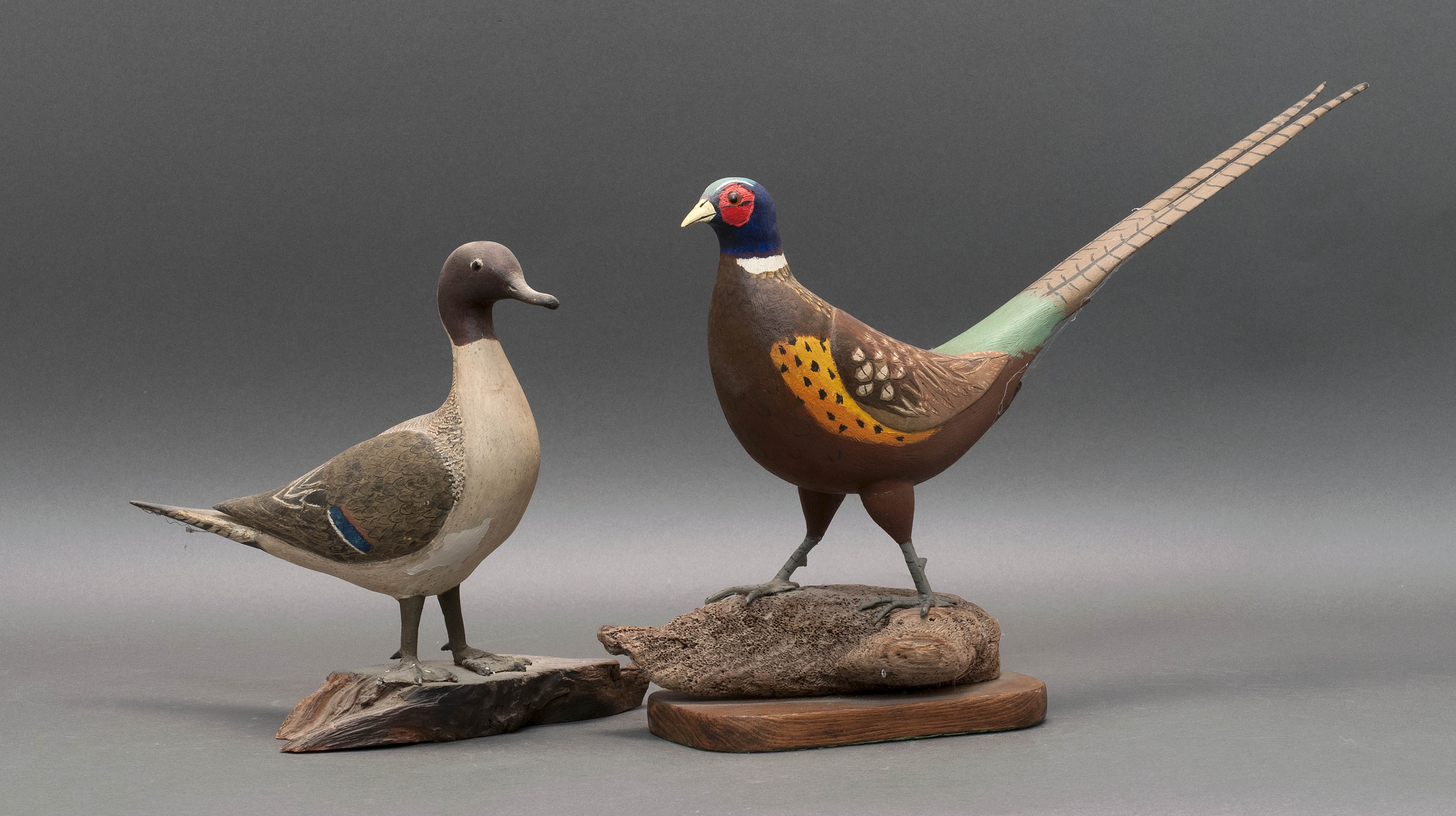 Appraisal: TWO DECORATIVE BIRD CARVINGS Circa A male ring-necked pheasant and