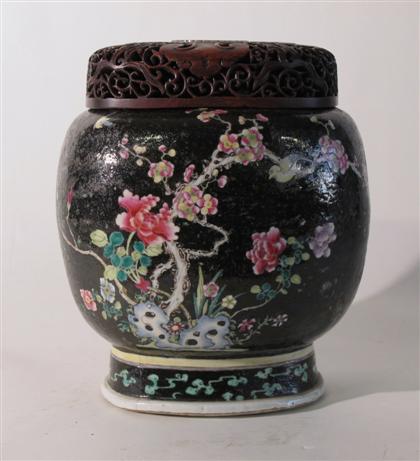 Appraisal: Chinese famille noire porcelain jar with hardwood and stone cover