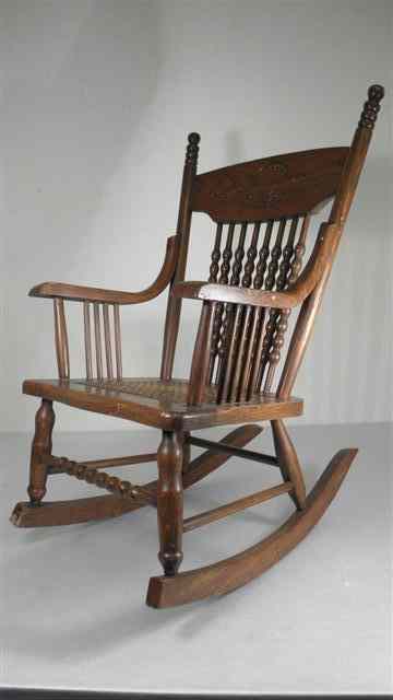 Appraisal: Child's antique oak rocking chair Cane woven seat spindle back