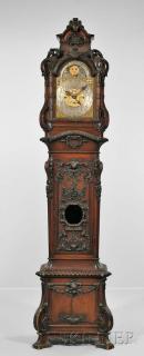 Appraisal: Elaborately Carved Mahogany Quarter-chiming Hall Clock Elaborately Carved Mahogany Quarter-chiming