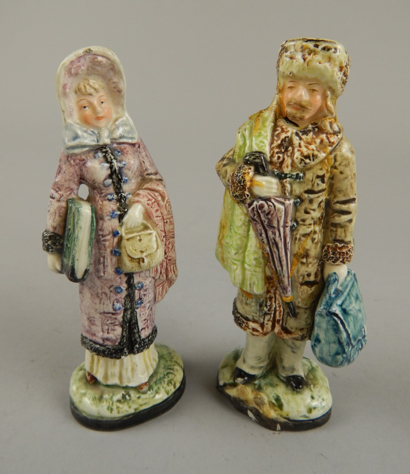 Appraisal: A pair of thC earthenware figures of a lady and