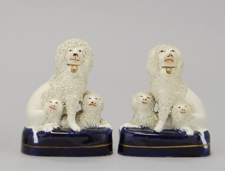 Appraisal: PAIR OF STAFFORDSHIRE FIGURES OF POODLES WITH PUPS Circa Height