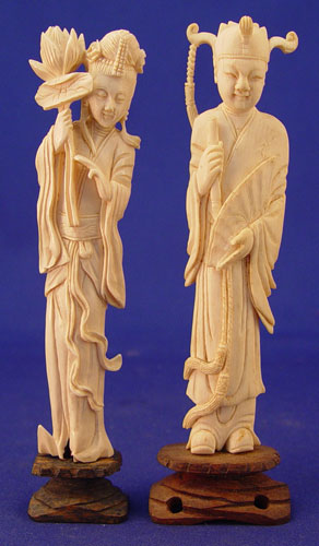 Appraisal: TWO CASED CARVED IVORY FIGURES Man and woman Man in