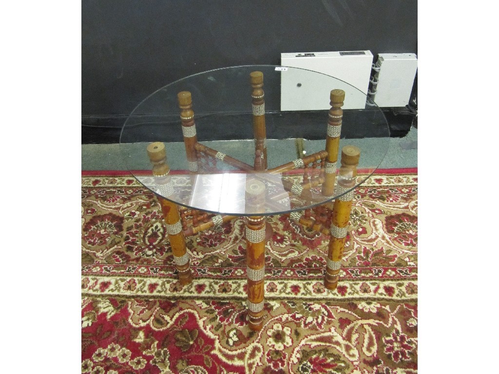 Appraisal: Glass top table on a carved folding stand