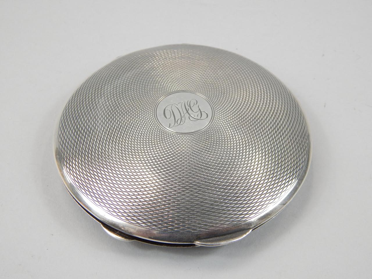 Appraisal: A George VI silver powder compact the spring loaded circular