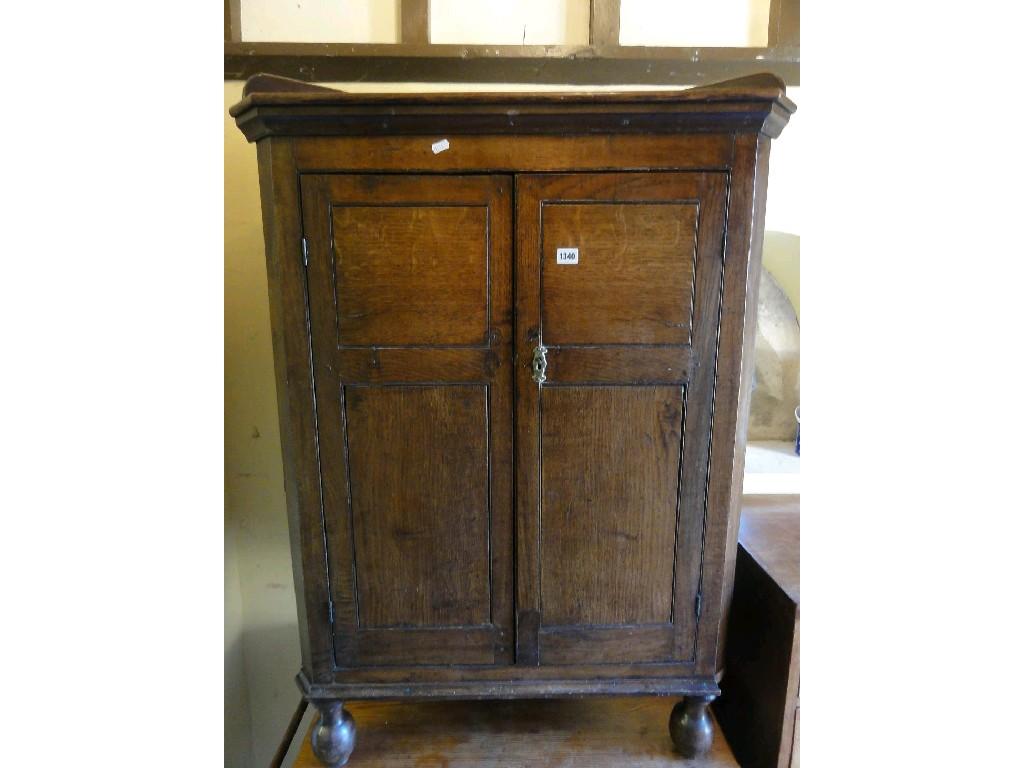 Appraisal: A th century oak corner cupboard enclosed by a pair