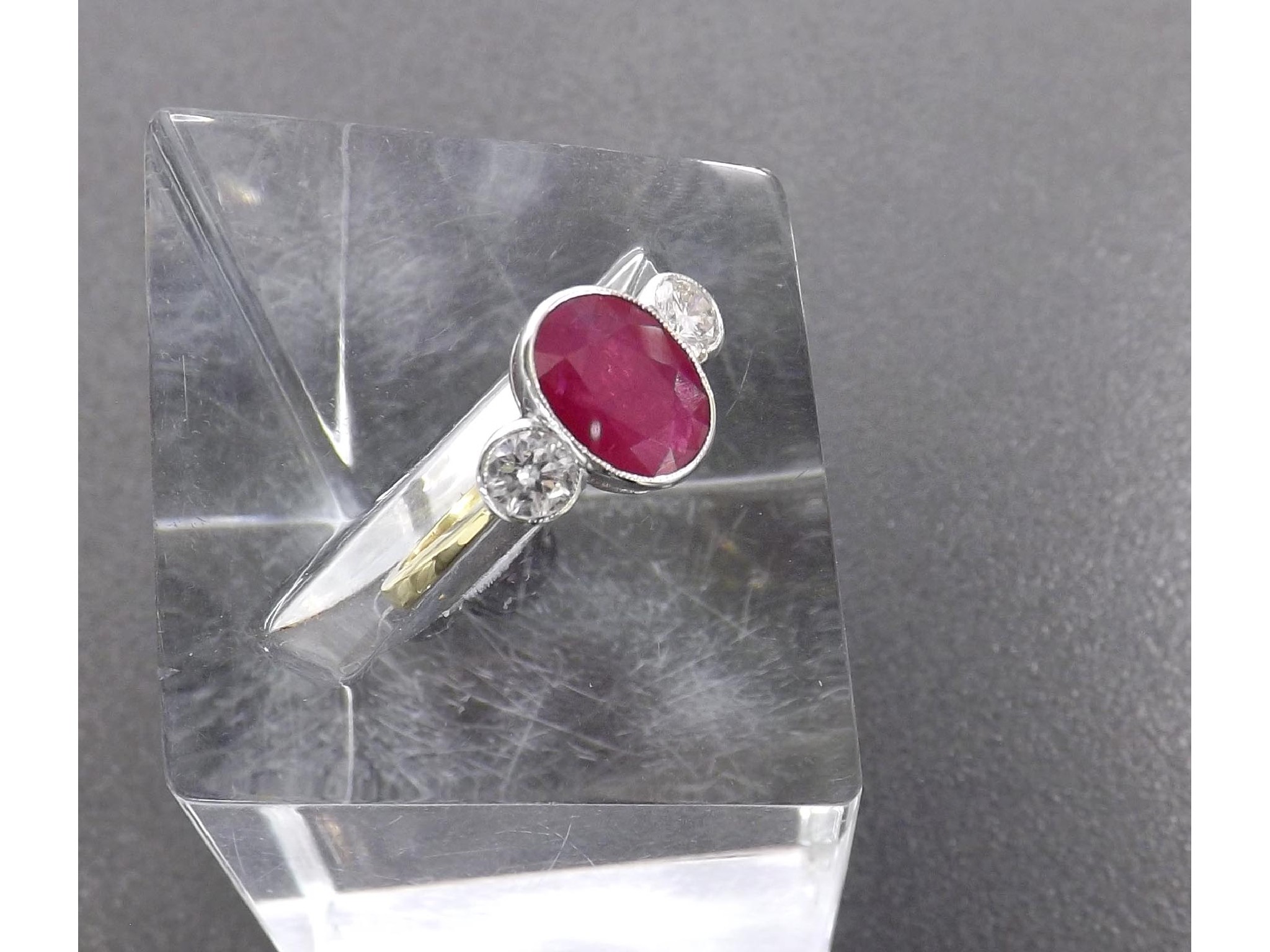 Appraisal: Ruby and diamond ct three stone ring the oval-cut ruby