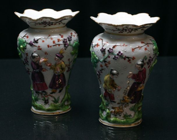 Appraisal: A pair of Continental figural vases with moulded figural decoration