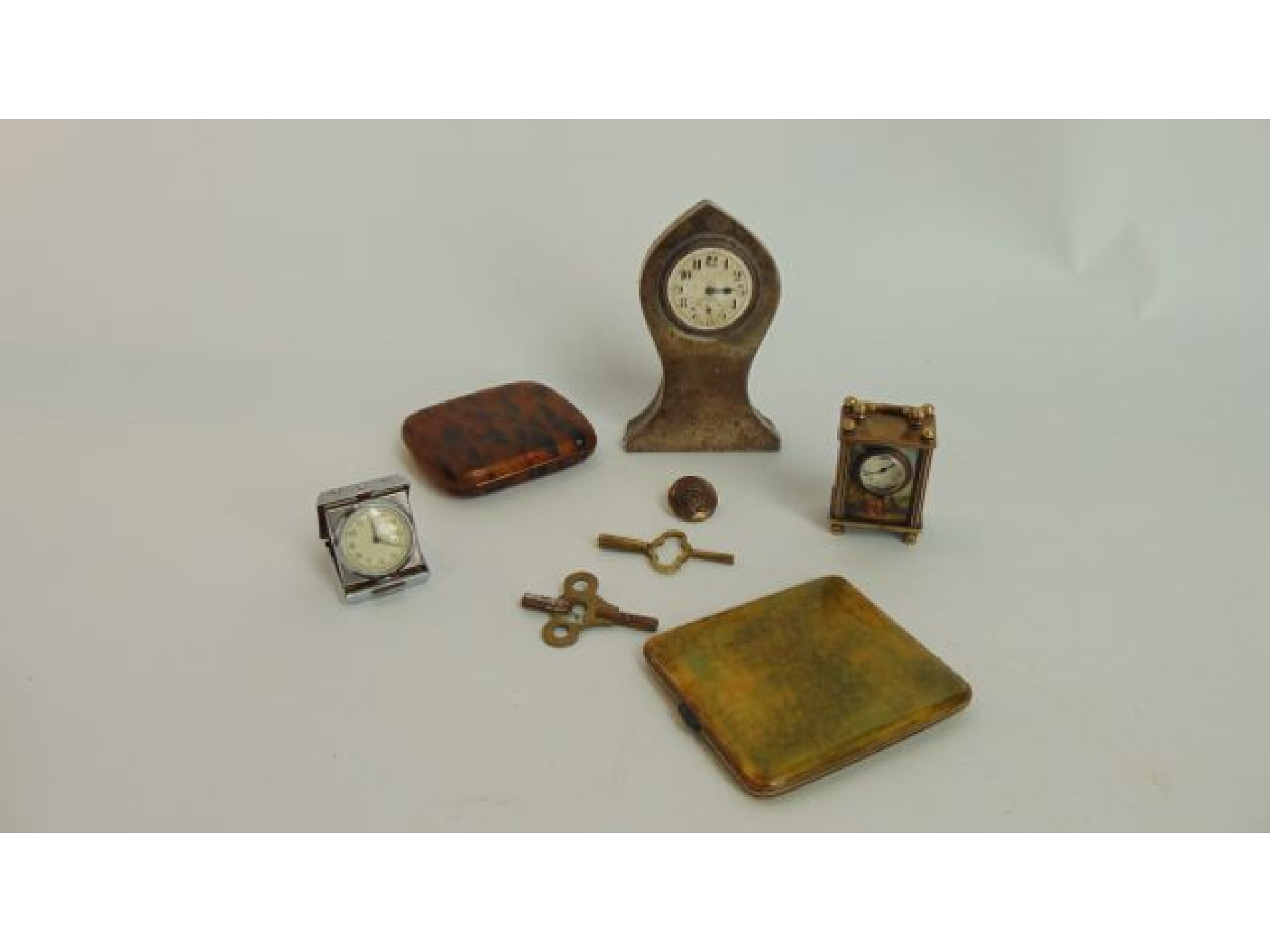 Appraisal: A small travel clock in an engine turned case an