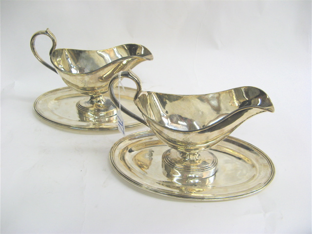 Appraisal: PAIR FRENCH CHRISTOFLE SILVER PLATED GRAVY BOATS with fitted underplates