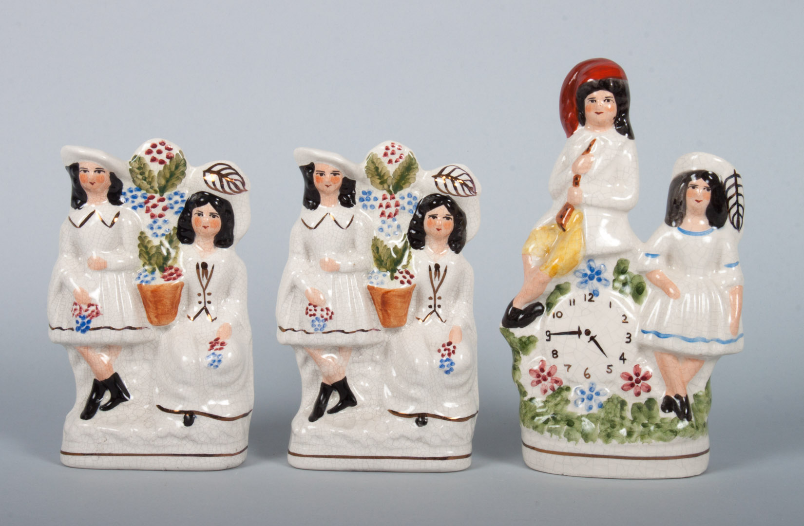 Appraisal: Three Staffordshire earthenware figural groups first quarter- th century pair