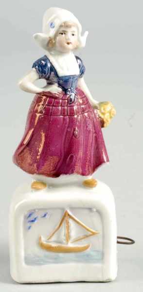 Appraisal: Dutch Girl on Pedestal Figural Tape Measure Description German Porcelain