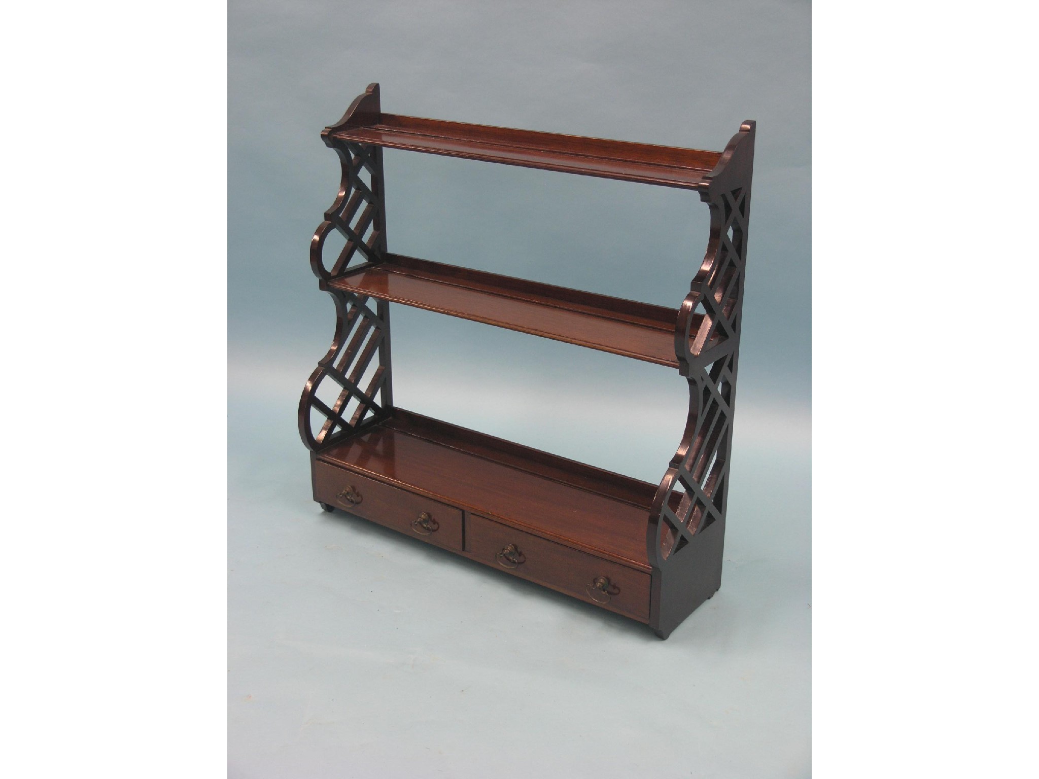 Appraisal: A Chippendale-style mahogany wall-hanging open bookcase two shelves and two