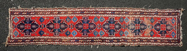 Appraisal: A Caucasian red ground runnerwith central medallions and geometric border