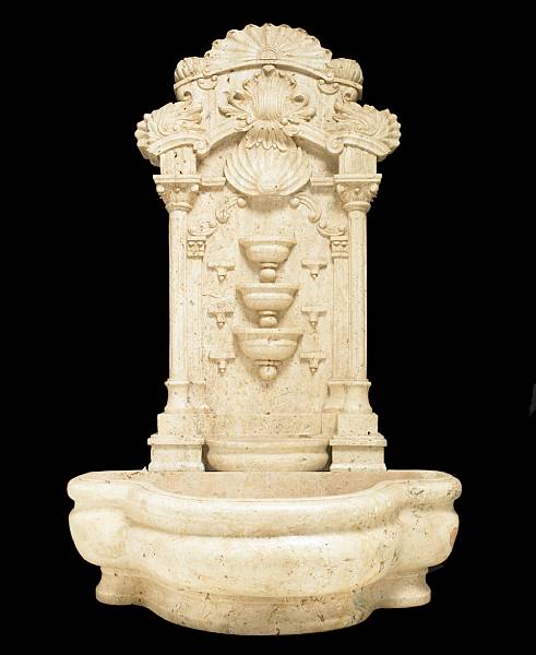 Appraisal: A Baroque style marble wall fountain The shaped basin surmounted