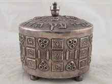 Appraisal: A white metal tests silver etrog box with decorated panels