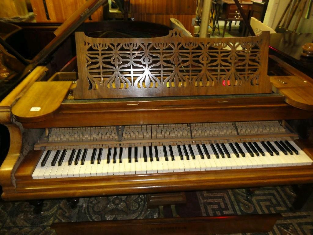 Appraisal: A Bechstein grand piano with faded walnut case and pierced