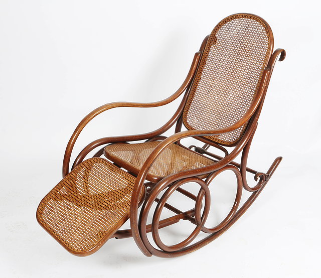 Appraisal: A THONET STYLE ROCKING CHAIR with caned back seat and