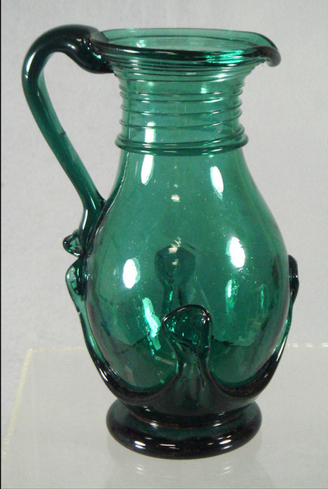 Appraisal: Free blown emerald green glass pitcher with lily pad decoration