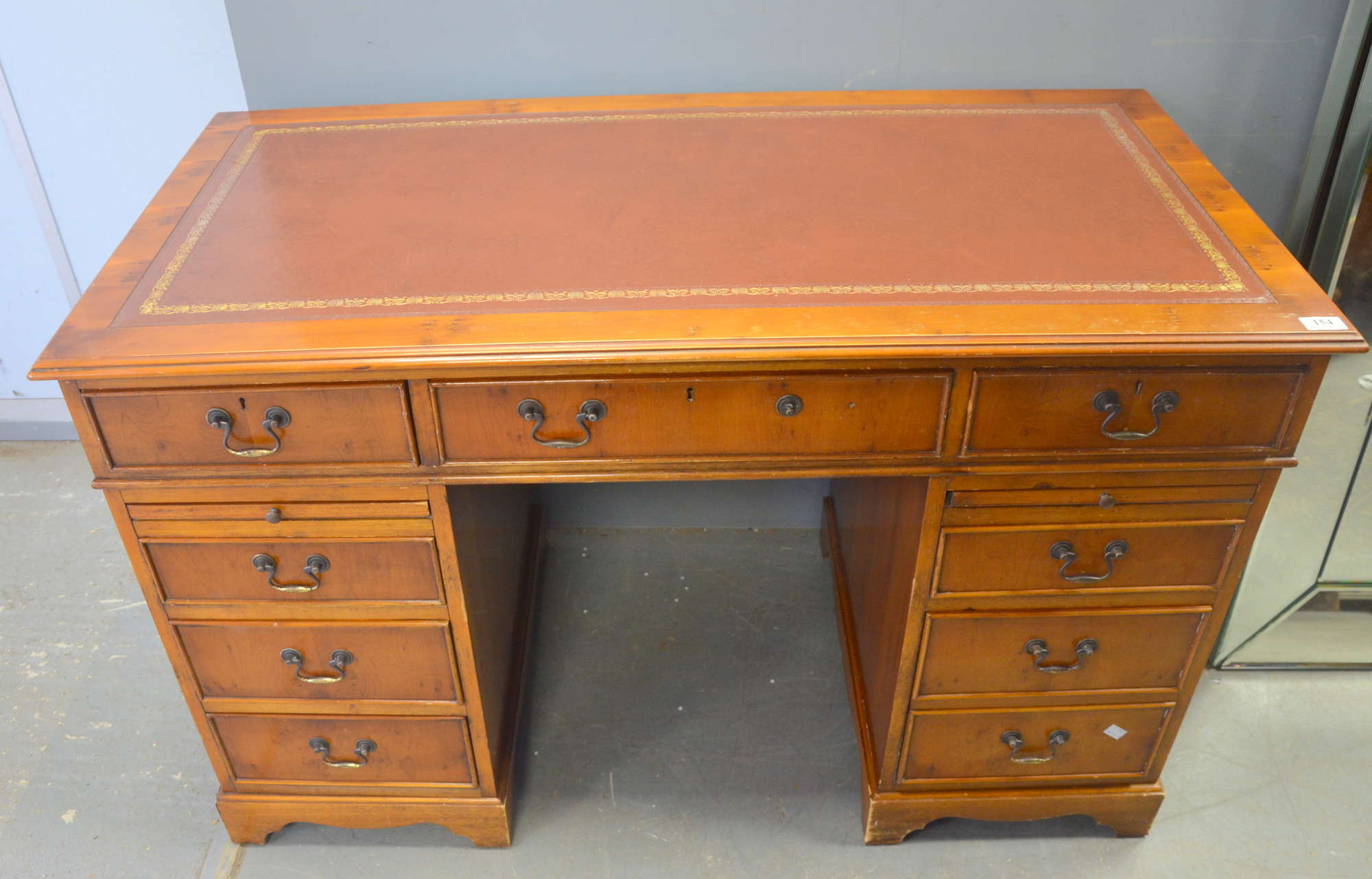 Appraisal: Walnut reproduction pedestal desk with red leather top