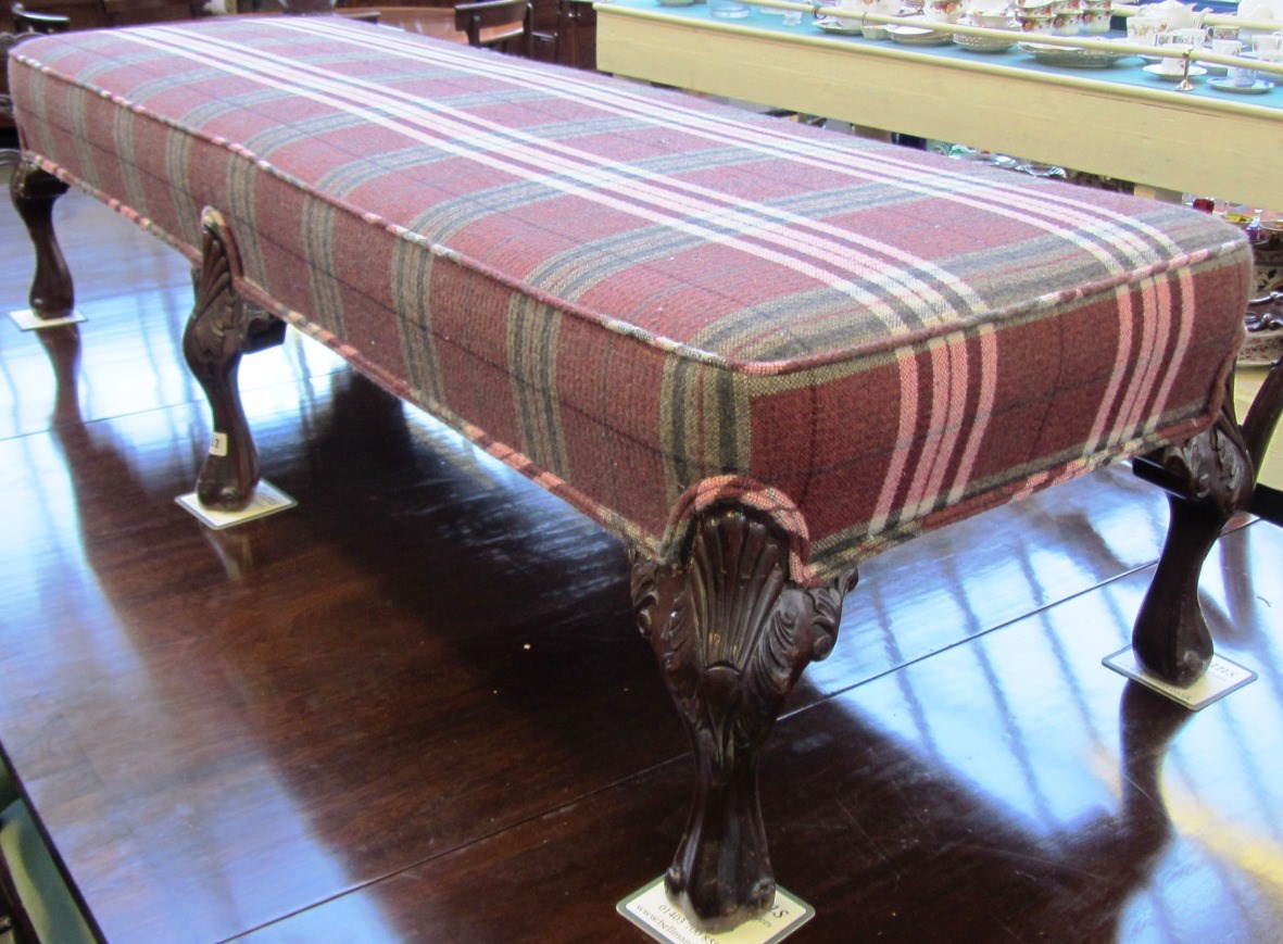 Appraisal: A large rectangular foot stool on six shell capped scroll