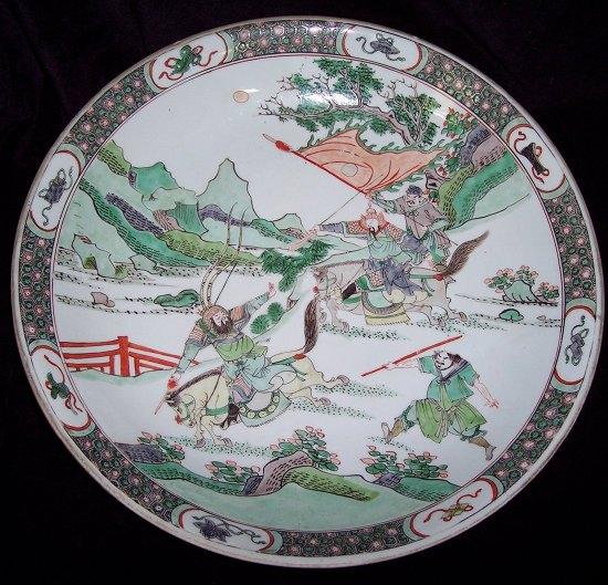 Appraisal: A large famille verte dish decorated warriors on horseback in