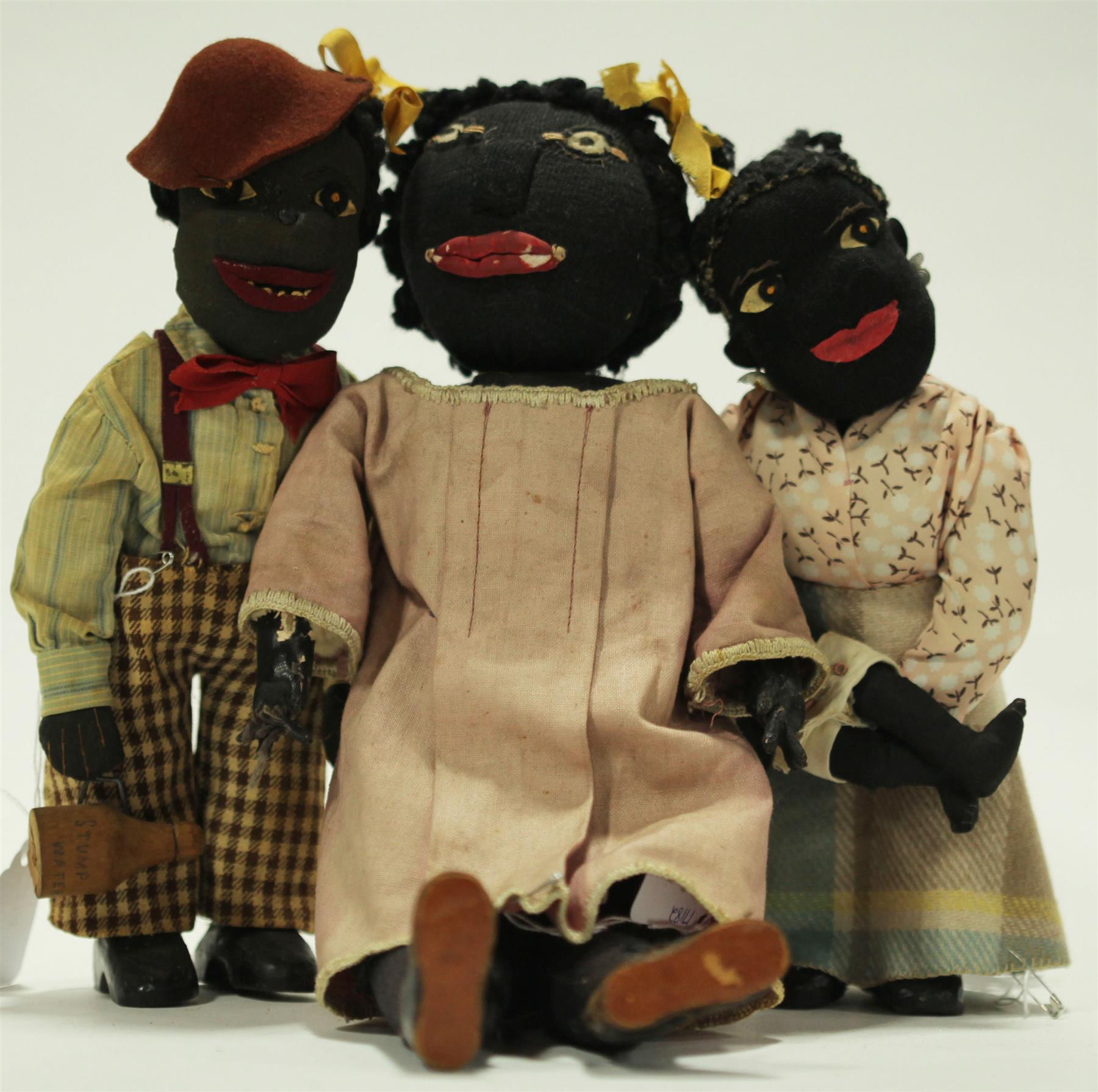 Appraisal: THREE CLOTH DOLLS Twentieth century dolls with stitched features These