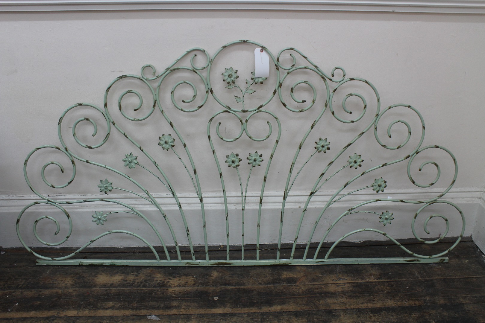 Appraisal: A wrought iron bed head th century of scrolling form