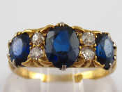 Appraisal: An carat gold carved half hoop sapphire and diamond ring