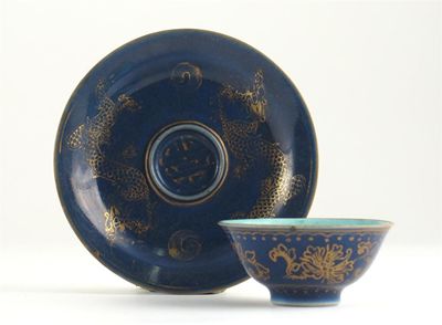 Appraisal: A Chinese blue ground teabowl and saucer decorated in gilt