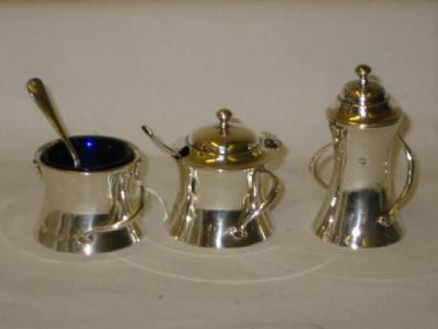 Appraisal: AN EDWARDIAN THREE PIECE CONDIMENT SET of waisted cylindrical form