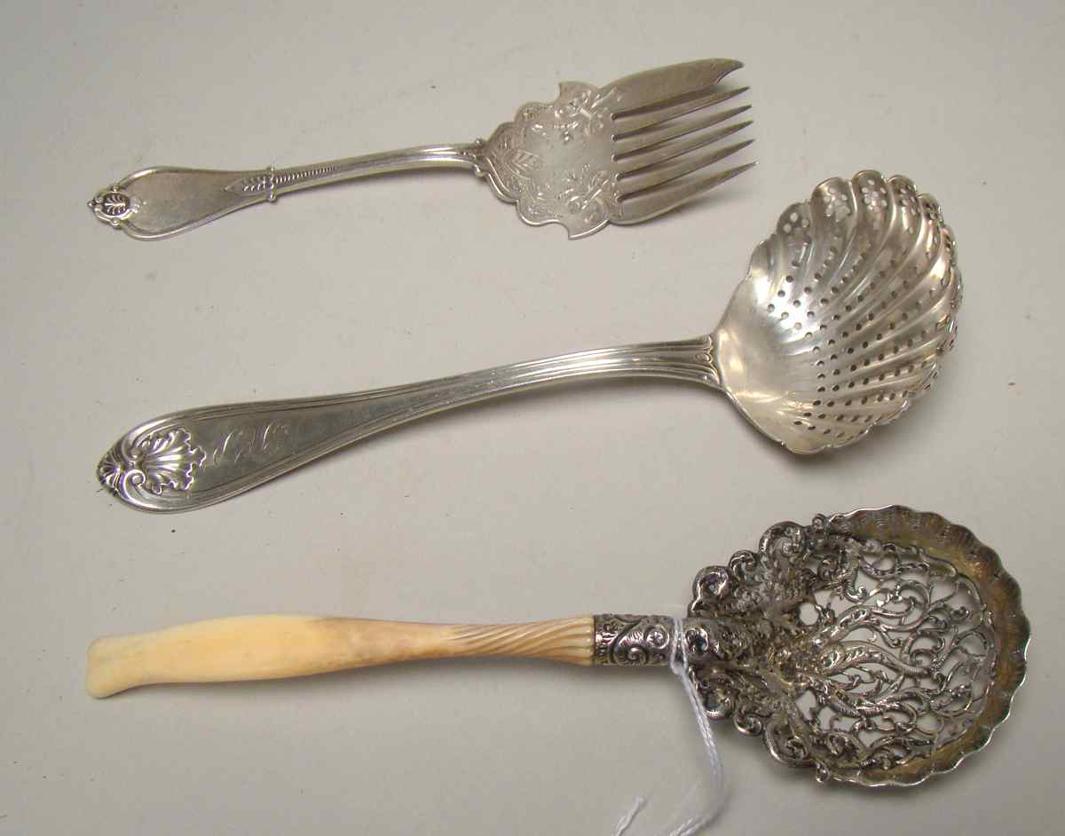 Appraisal: THREE AMERICAN SILVER SERVING PIECES Including an ivory-handled pierced spoon