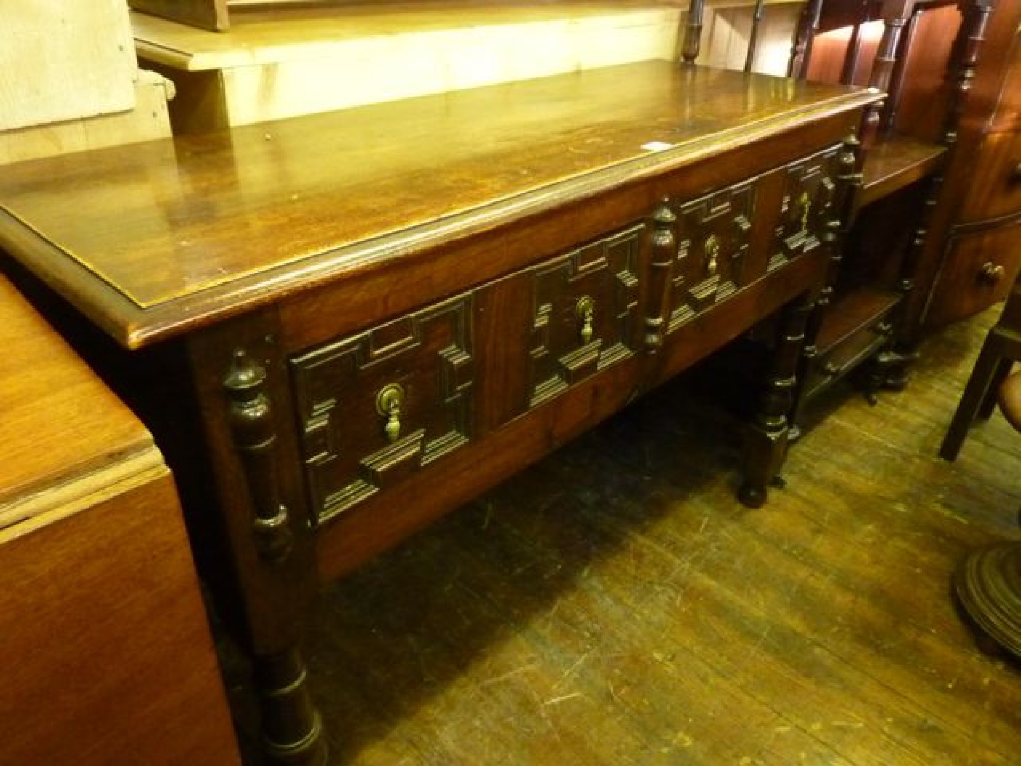 Appraisal: An Edwardian oak side table in the Jacobean manner fitted