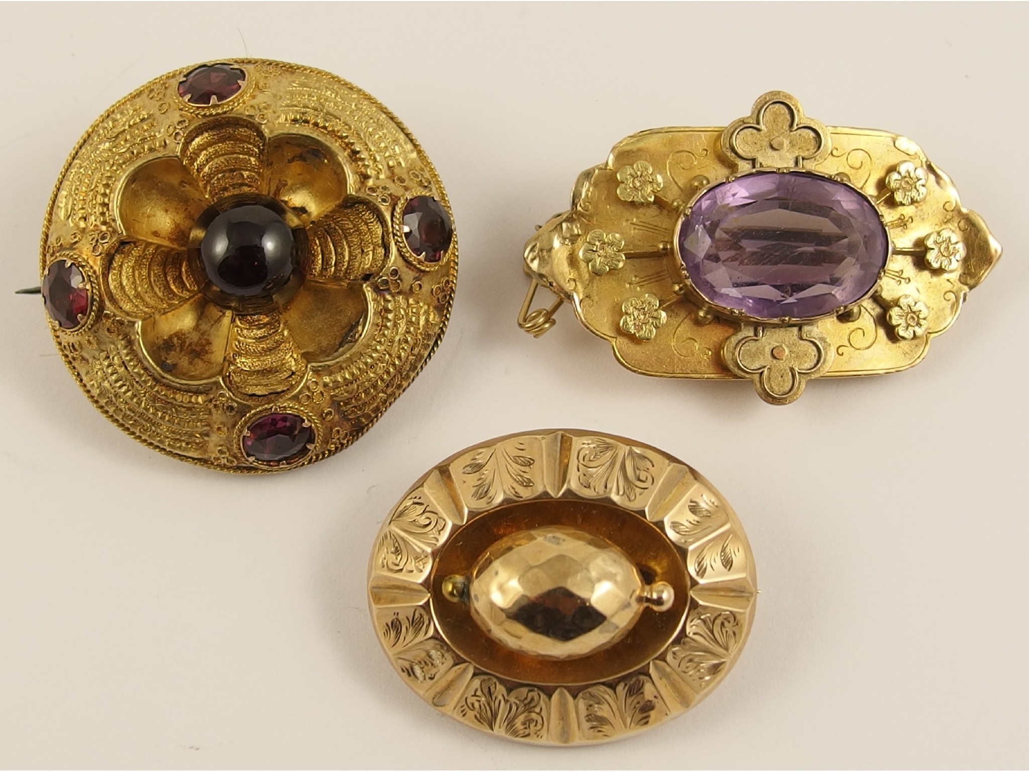 Appraisal: Three Victorian yellow metal broochesa circular example set with both