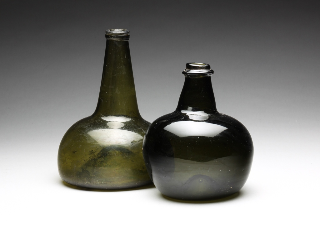 Appraisal: TWO ENGLISH BLOWN GLASS OLIVE BOTTLES Eighteenth century Applied lips