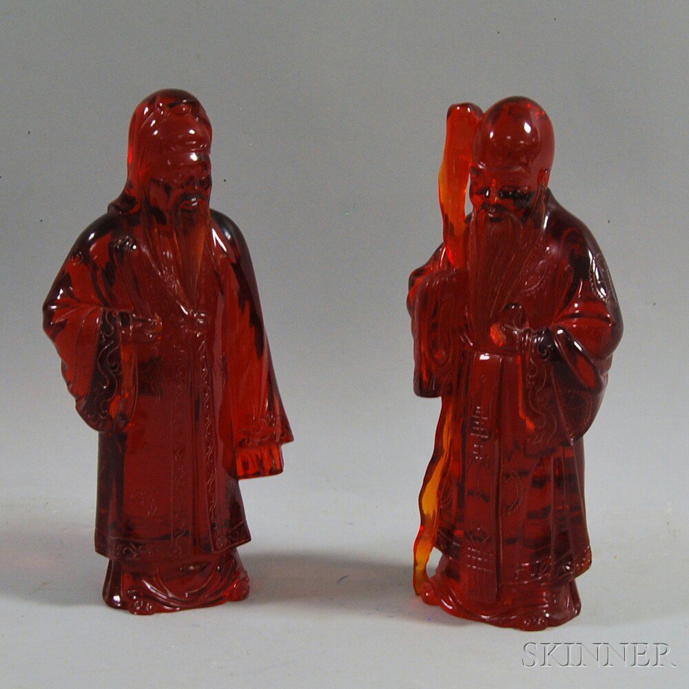 Appraisal: Pair of Chinese Red Resin Figures th century carved to