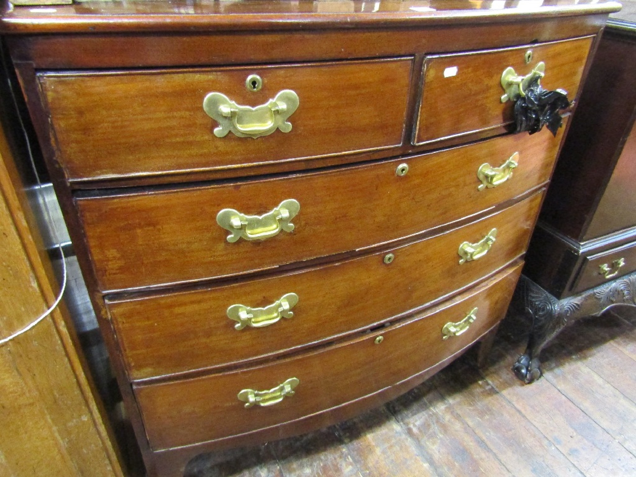 Appraisal: A th century mahogany bow fronted chest of three long