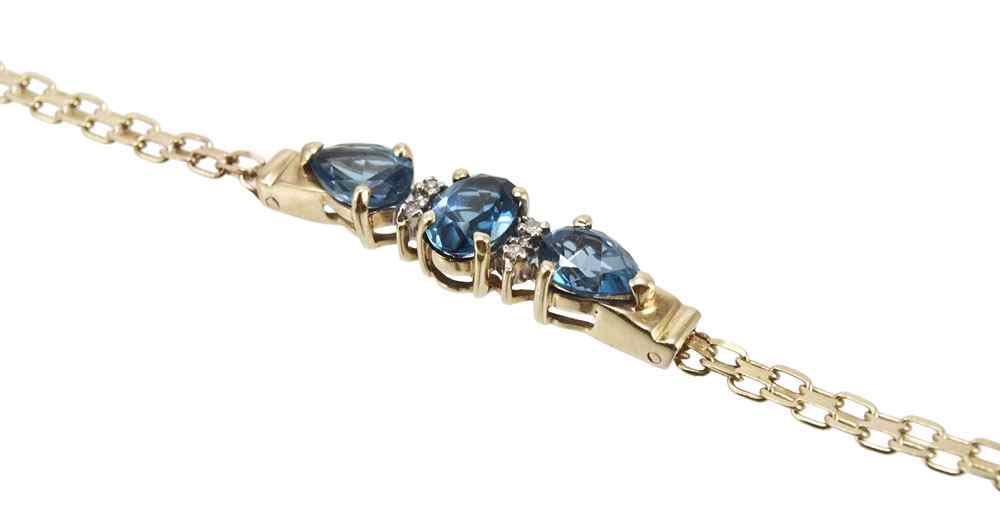 Appraisal: K DIAMOND TOPAZ BRACELET K yellow gold bracelet contains round