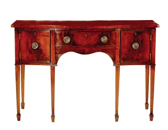 Appraisal: English mahogany serpentine sideboard late th century shaped top over