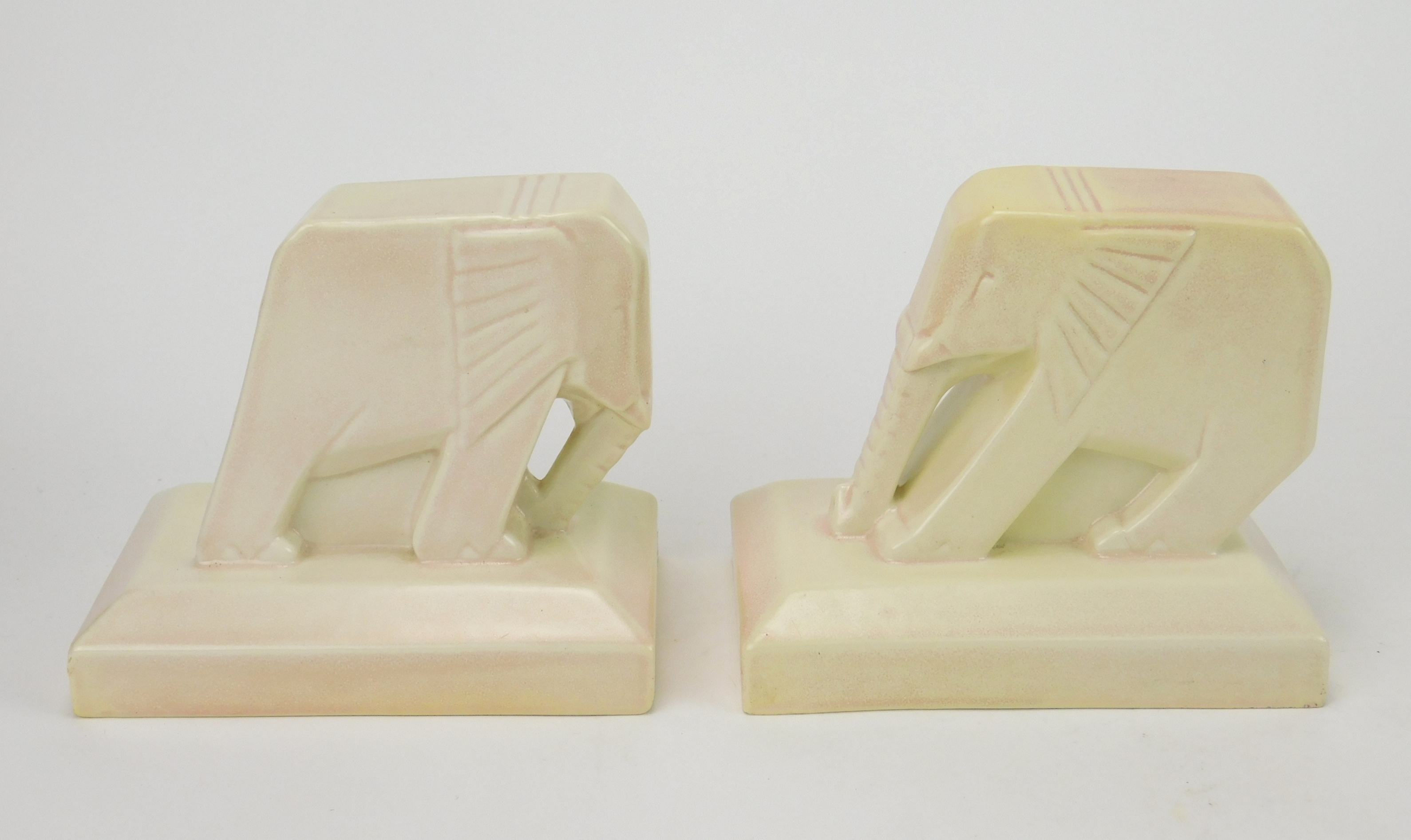 Appraisal: Pair of Cowan pottery bookends- push elephants in ivory glaze