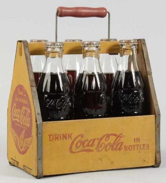 Appraisal: Wooden Coca-Cola Carrier Bottles Description s Bottles are filled capped